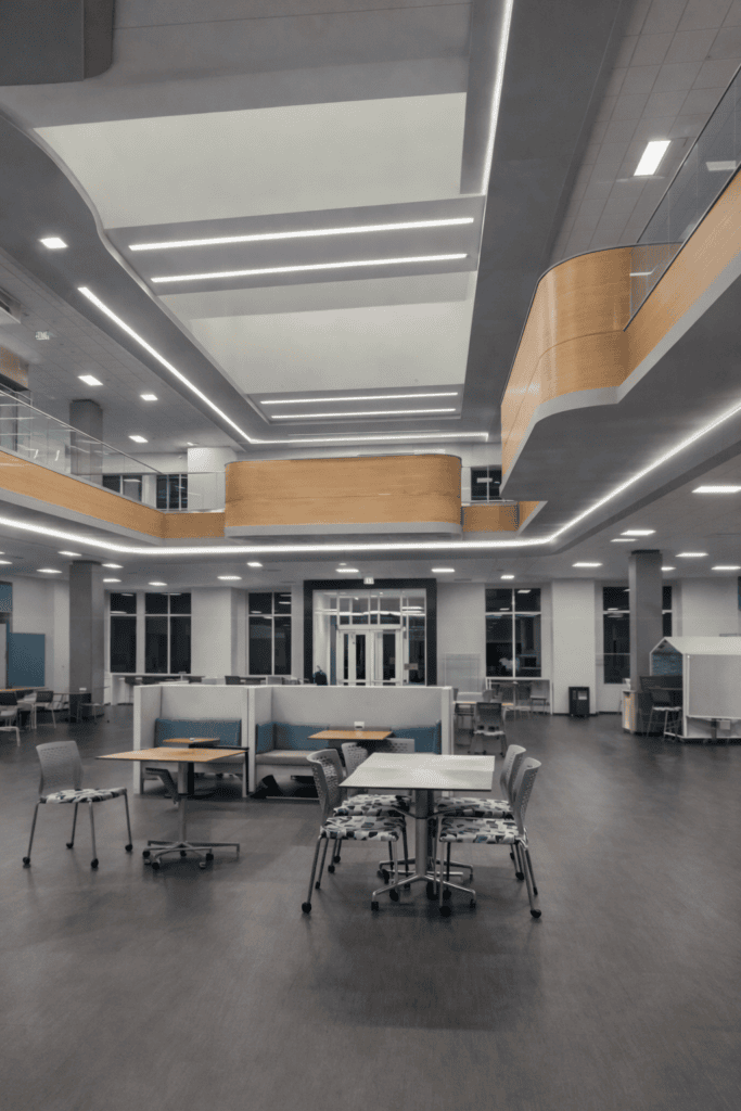 Lighting solutions for a large-scale educational interior designed to feel clean, functional, and inviting.
